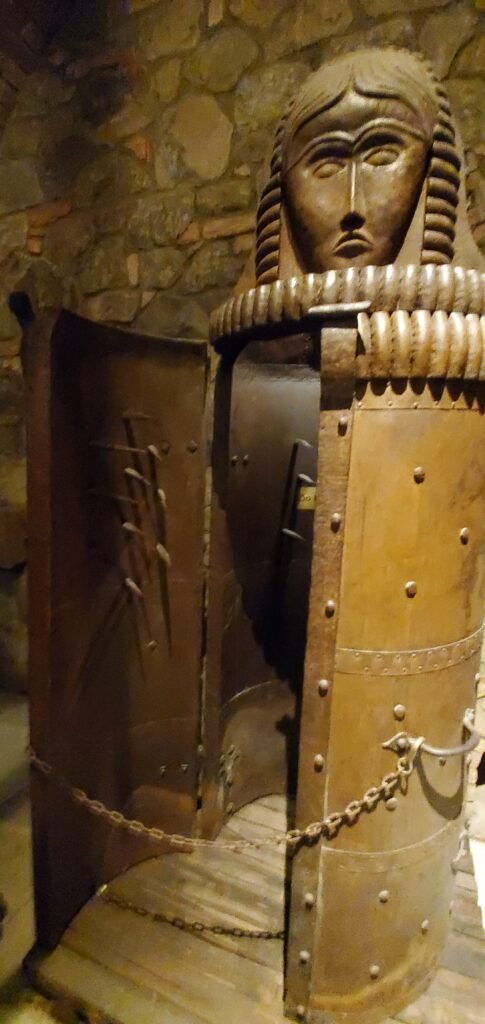 An Iron Maiden torture device with sculpture in the Castello di Amorosa castle dungeons.